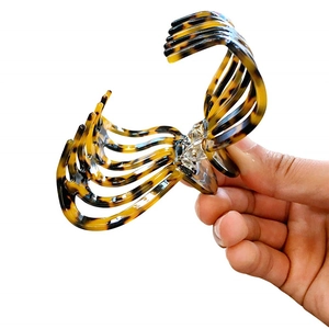 Large leopard tortoise hair claw clip made of premium acetate held by hand