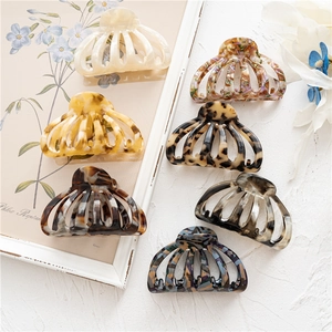 Detailed collection of seven leopard and floral acetate hair claws in various patterns