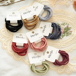 Macro shot of colorful high elasticity hair bands set on a vintage lace table mat