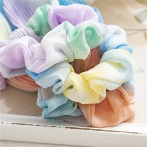 Gros plan détaillé de chouchous tie-dye plissés en mousseline aux couleurs pastel
