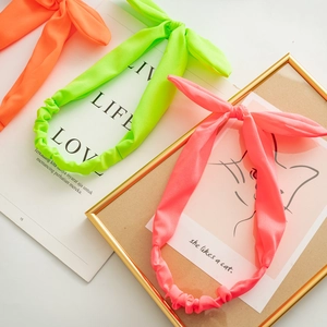 Neon fabric bunny ear elastic headbands in fluorescent green, orange, and coral pink