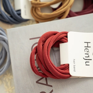 Close-up of colorful seamless elastic hair bands set with woven texture on card