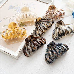 Detail view of large acetate hair claws in various leopard and marble textures