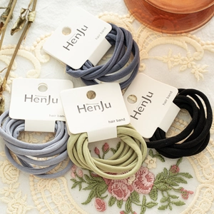 Detail of macaron elastic hair bands on lace cloth with soft morandi color tones