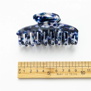 Blue and white marble acetate hair claw clip 8.5cm size shown with measuring ruler
