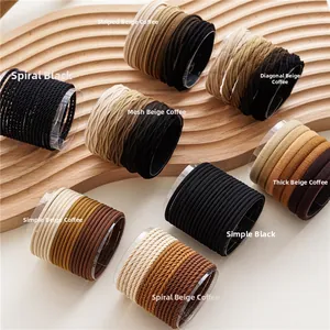 Detailed view of elastic hair ties showing eight distinct fabric textures and earth tones