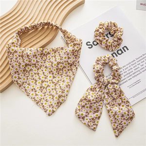 Close-up of three-piece floral hair set with triangle scarf and daisy print scrunchies