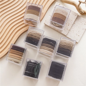 Neutral tones seamless elastic hair ties set in clear boxes with woven and spiral textures
