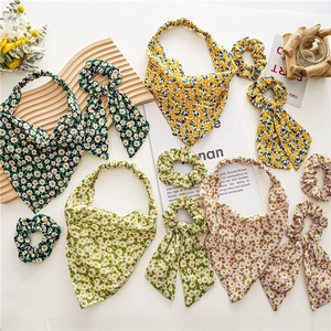 Floral print headscarf and scrunchie set with daisy patterns in vibrant summer colors