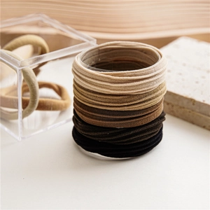 Detail shot of high-elastic seamless hair ties in gradient earth tones on display stand