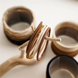 Macro shot of seamless high-elastic hair ties in earth-toned ribbed texture fabric