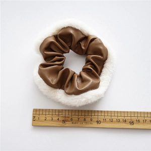 Retro PU leather and plush faux fur scrunchie in brown and white shown with ruler for size
