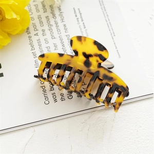 Detail of tortoise shell acetate hair claw with durable metal spring for secure styling