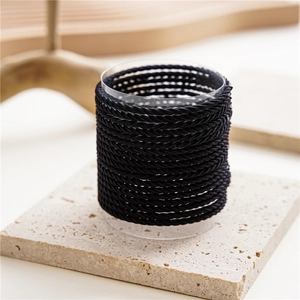 Detailed view of high-elastic black seamless hair ties on a clear support stand