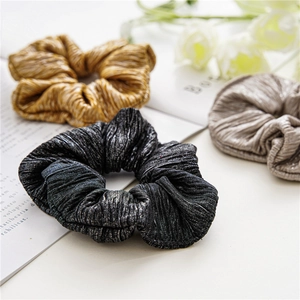 Lot de trois chouchous en tissu brillant de couleurs or, noir et gris argenté