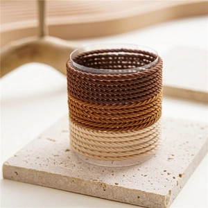 Detail of coffee-colored high elasticity seamless hair ties on a display stand
