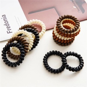 Durable matte spiral hair ties in earthy colors like black and brown for high elasticity
