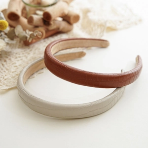 Detailed close-up of brown and beige snakeskin pattern PU leather headbands