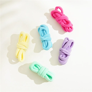 Close-up of five colorful high-elastic hair ties in soft pastel fabric texture