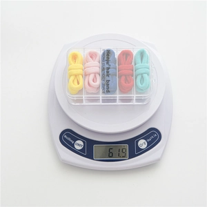Weight display of 25 colorful high elastic hair ties in a clear storage box
