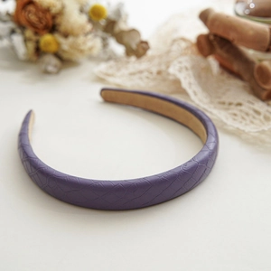 Close-up of purple faux leather headband featuring elegant crocodile pattern texture
