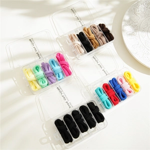 Detailed view of colorful high elasticity hair band sets in transparent plastic storage boxes