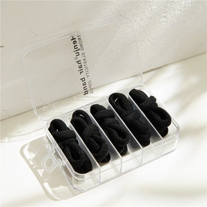 Detailed view of 25-piece black high-elastic hair bands in a transparent 5-slot storage box
