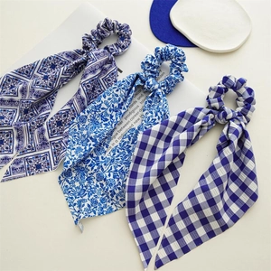Three-piece blue satin hair scrunchies with long ribbons in floral and plaid patterns