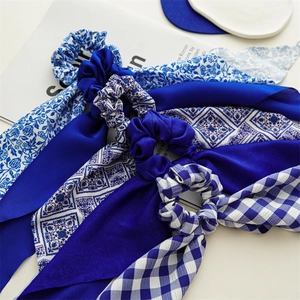 Blue and white satin scrunchies with long streamers in various floral and plaid patterns