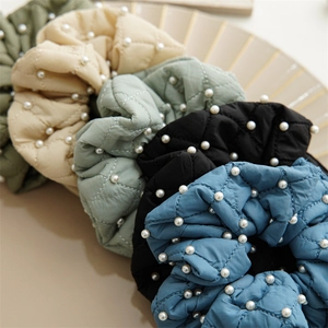 Quilted fabric scrunchies with white pearls in beige, gray-green, black, and blue tones