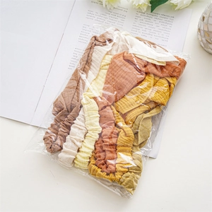 Flat lay macro of multi-color elastic fabric headbands in neutral earth tones