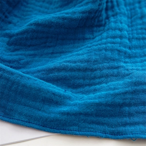Macro shot of blue muslin cotton fabric texture and precise stitching on the hair band