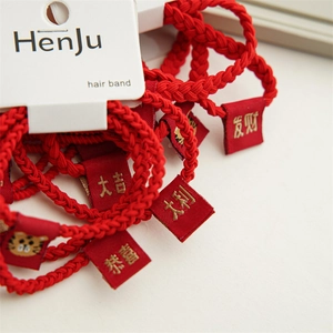 Close-up of red seamless high-elastic hair bands with gold festive tiger embroidery labels