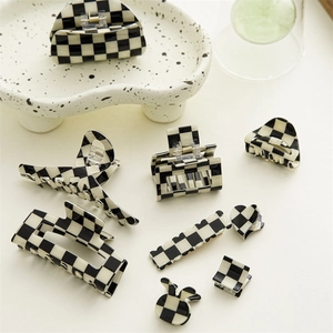 Collection of black and white checkerboard hair claws in various geometric shapes