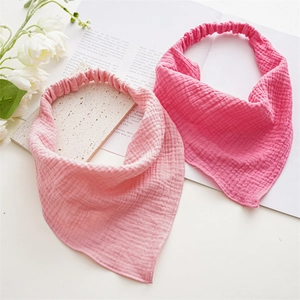 Detail showing soft crinkle gauze texture and elastic band of pink baby headbands