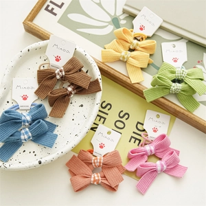 Detail view of colorful bow hair ties set with ribbed fabric texture and plaid accents