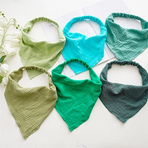 Close-up of six-pack textured cotton gauze baby bandanas in varied shades of green and teal