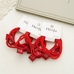 Red woven hair rings with golden Tiger Year patterns and festive greeting labels