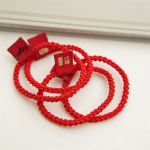 Close-up of red high-elastic seamless hair ties featuring tiger theme woven labels