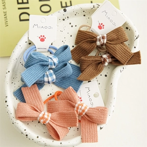 Three pairs of candy-colored bow hair ties in blue, brown and pink orange for girls