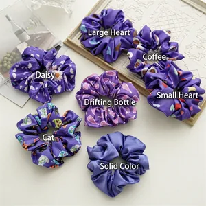 Set of 7 purple periwinkle blue floral and pattern satin hair scrunchies on white desk