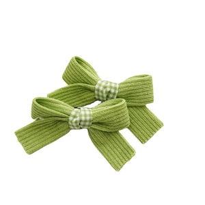 Pair of green knit bow hair ties with checkered cotton details for girls' hairstyles