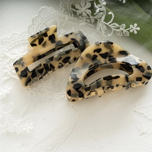 Close-up of tortoise shell pattern hair claws with square and curved acetate designs