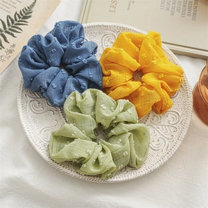 Three-piece seersucker scrunchie set in blue, yellow, and green with textured dots