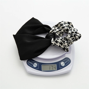 Detail showing checkered scrunchie with bow knot on a scale weighing 17.4g