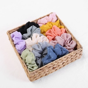 Close-up of colorful seersucker scrunchies set with checkered fabric texture in a basket