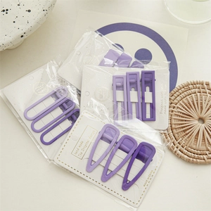 Detail view of purple candy color hair clip set on handmade display card packaging