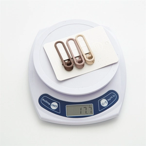 Three matte oval hollow hair clips in Morandi colors shown on a scale weighing 17.7g