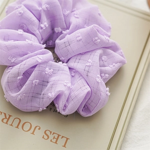 Detail showing lavender seersucker fabric texture and polka dots on scrunchie