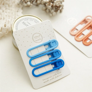 Three gradient blue matte hair clips displayed on decorative card with dried flowers